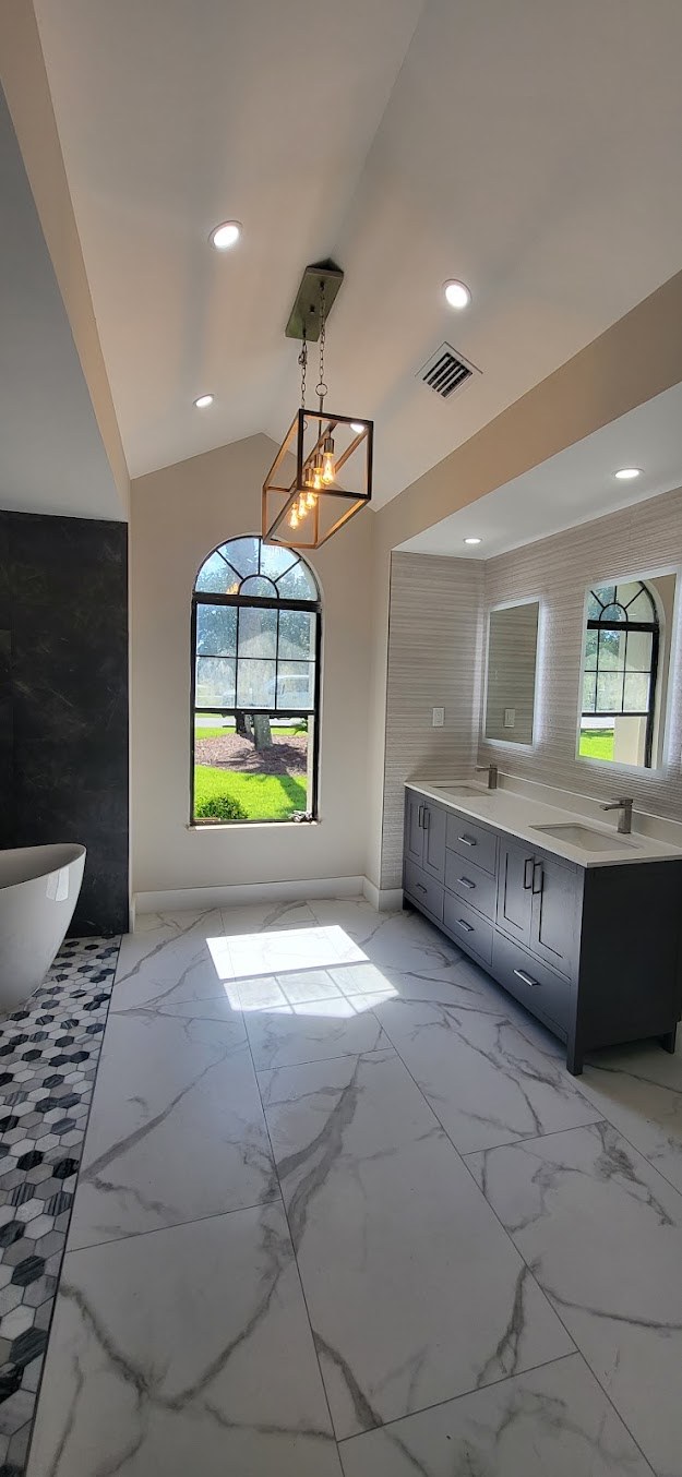 Finished bathroom with decorative lighting and tiled flooring