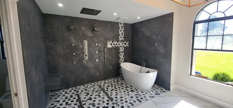 Completed bathroom with freestanding tub and tiled shower from Raven's portfolio